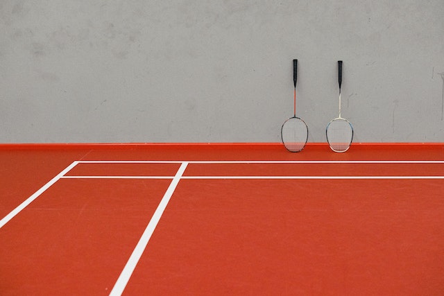 two rackets in a badminton court